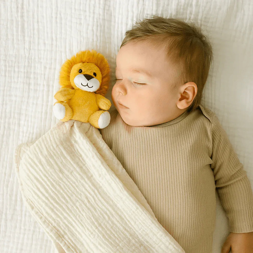 Yellow plush lion security blanket for babies made of soft fabric shown with sleeping baby