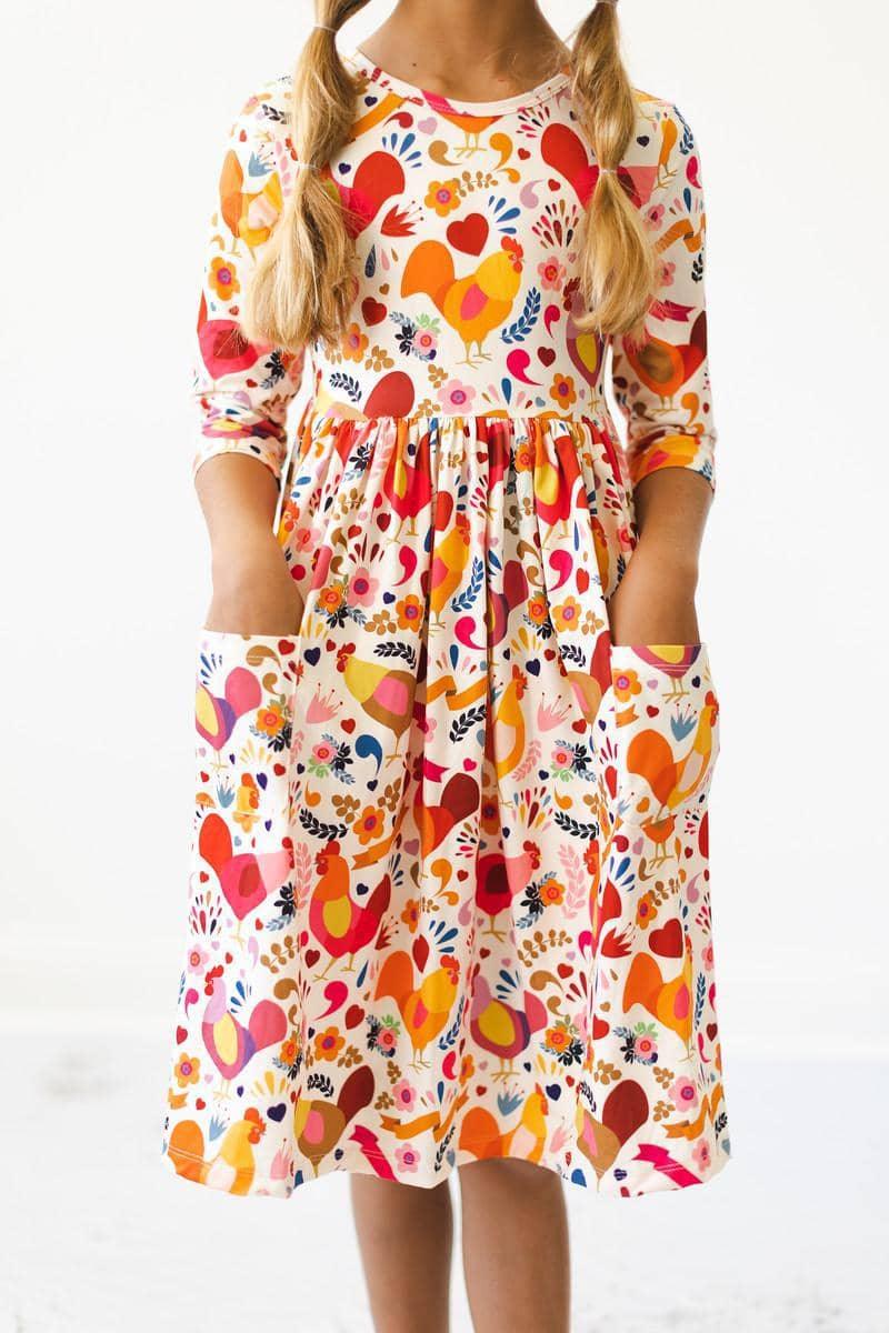 Girls little red hen dress by Mila & Rose with 3/4 sleeves and twirl pocket design in colorful print