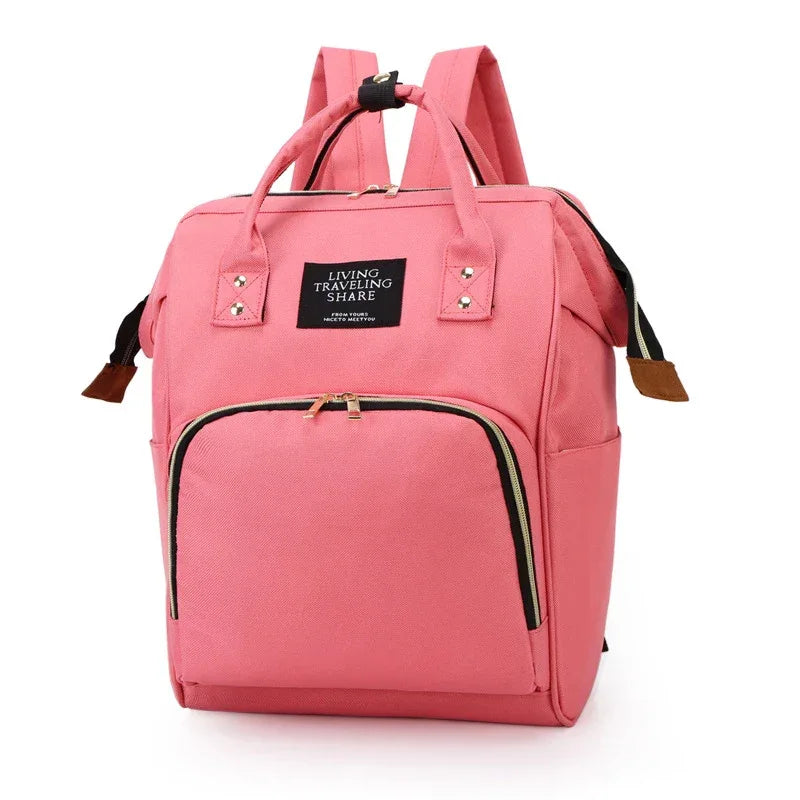 pink multifunctional insulated diaper bag for babies and kids with multiple compartments and backpack straps