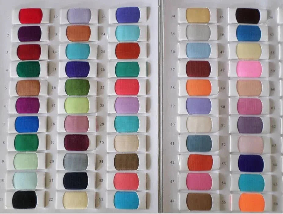 Colorful selection of fabric swatches for babies and kids clothing including blue red green and purple shades
