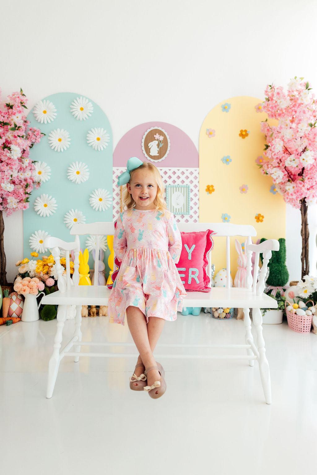 Preppy Peeps 3/4 Sleeve Pocket Twirl Dress worn by a smiling girl in a pastel Easter-set, twirly and easy to wear