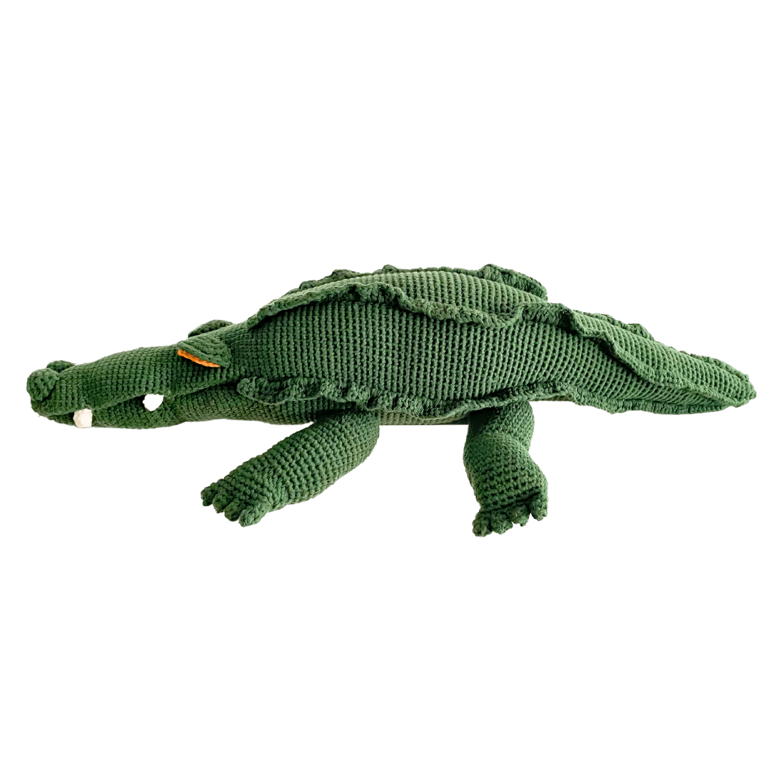 Large green crochet crocodile stuffed animal with a ridged back, toothy face, and organic cotton detail.