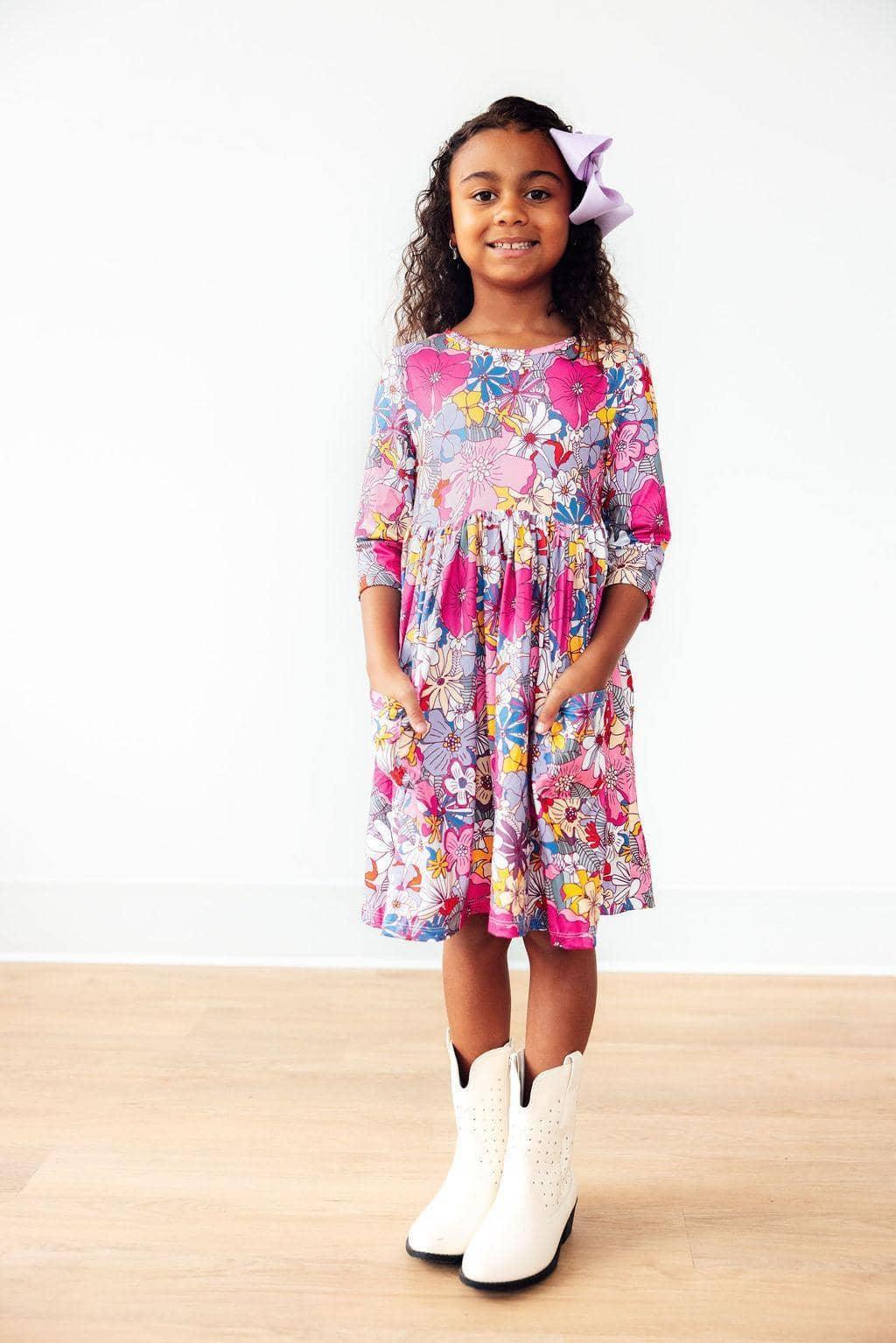 Mila & Rose mauve floral girls twirl dress with 3/4 sleeves and pockets, worn by a young girl