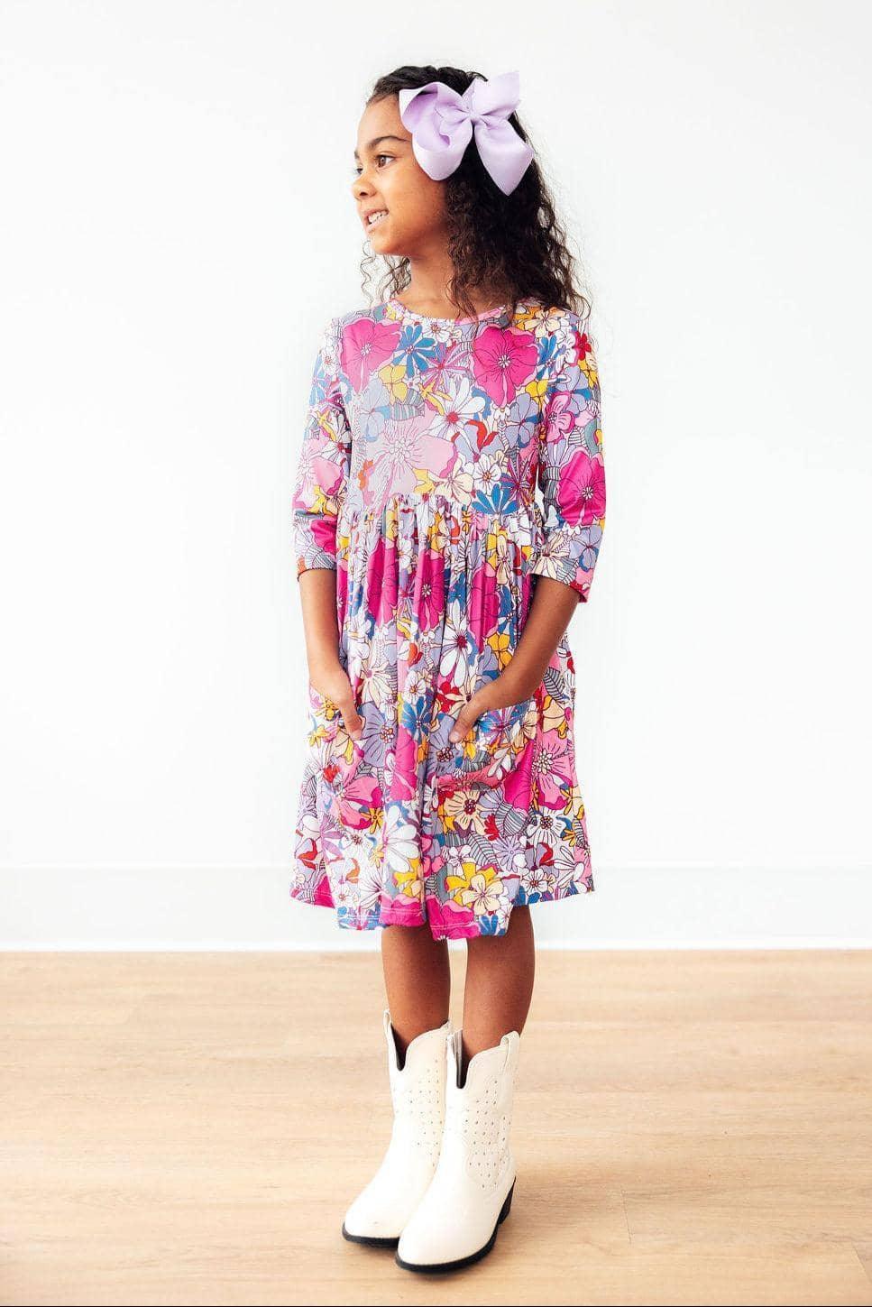 Mila & Rose mauve floral girls twirl dress with 3/4 sleeves and pockets, worn by young girl