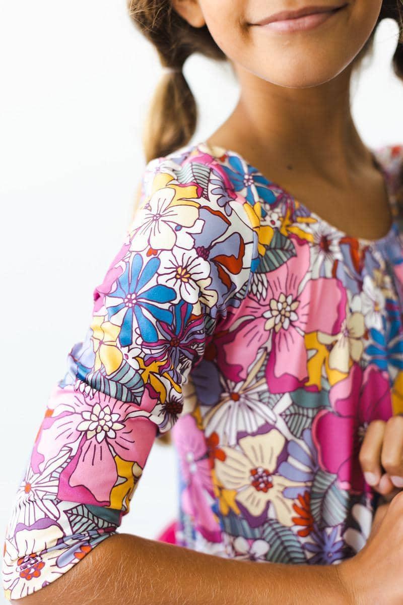 Close-up of girl wearing mauve tutu leotard for girls with colorful floral posing