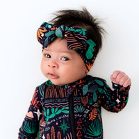 Baby wearing The SoftKnot Bow | Desert Cactus (Midnight) head-wrap bow in cozy bamboo fabric.