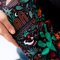 The Second-Skin Footie, Desert Cactus Midnight, with 'Mama, I Wished for You' print on dark fabric.