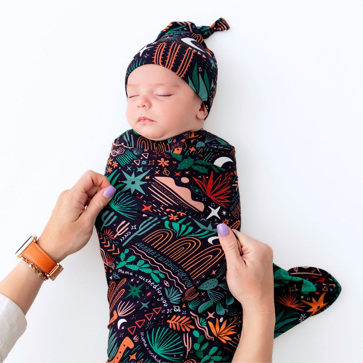 Newborn swaddled in Desert Cactus Midnight Forever Swaddle Blanket, oversized 48x48 bamboo blend.