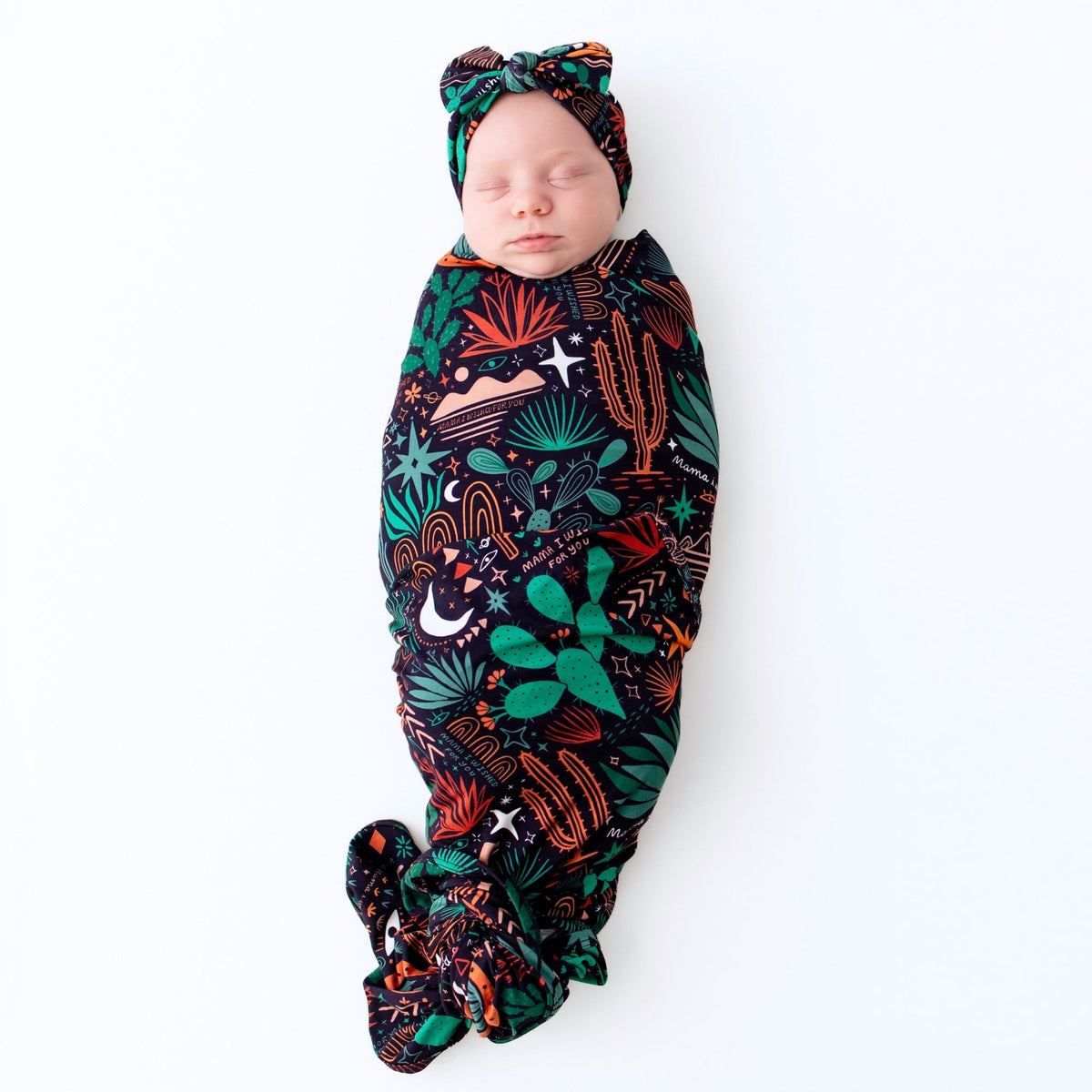 Newborn swaddled in The Forever Swaddle Blanket Desert Cactus Midnight, 48x48, bamboo blend keepsake.