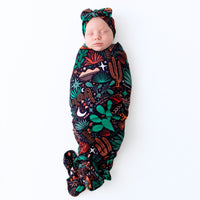 Newborn swaddled in The Forever Swaddle Blanket Desert Cactus Midnight, 48x48, bamboo blend keepsake.
