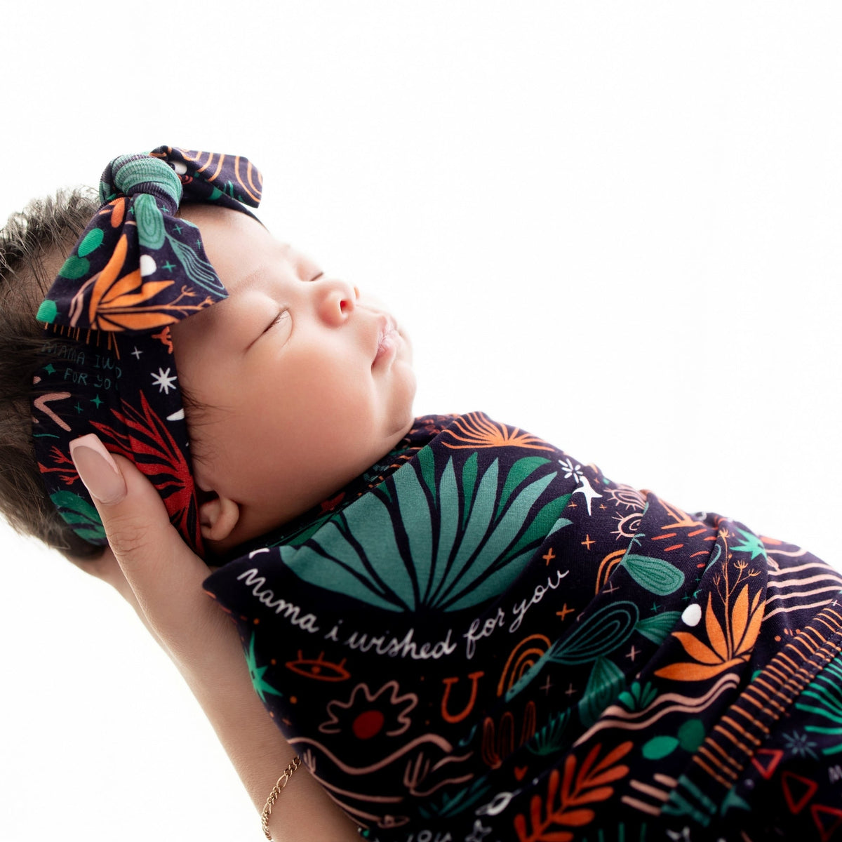 Baby snug in The Forever Swaddle Blanket Desert Cactus Midnight, 48x48 bamboo blend swaddle.