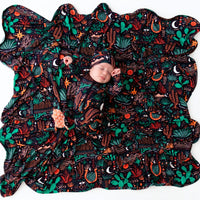 Baby in midnight desert cactus print footed zippered onesie with Mama, I Wished for You message.
