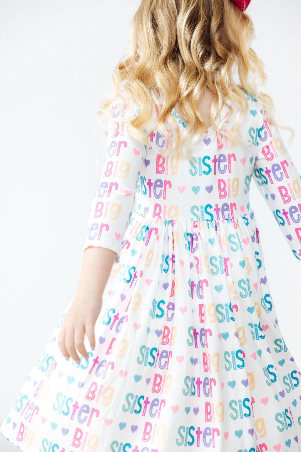 Big Sister 3/4 Sleeve Pocket Twirl Dress for Girls displayed on a cheerful young girl, showcasing a delightful twirl skirt designed for fun and play. Perfect twirl dress for girls that combines comfort and style.