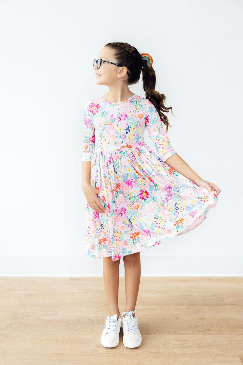 Adorable Field of Flowers 3/4 Sleeve Pocket Twirl Dress for Girls featuring a charming scoop back neckline, designed for comfort and style during every twirl and spin.