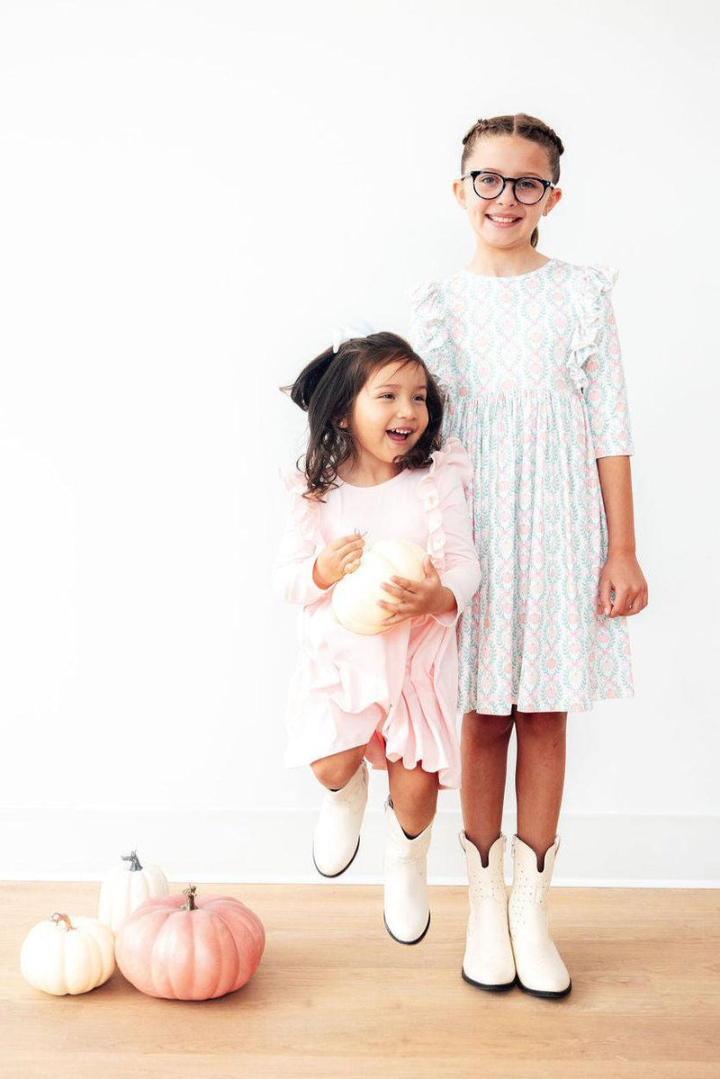 Charming details of the Pumpkin Kisses, Harvest Wishes 3/4 Sleeve Ruffle Twirl Dress showcasing its soft fabric and playful ruffles.