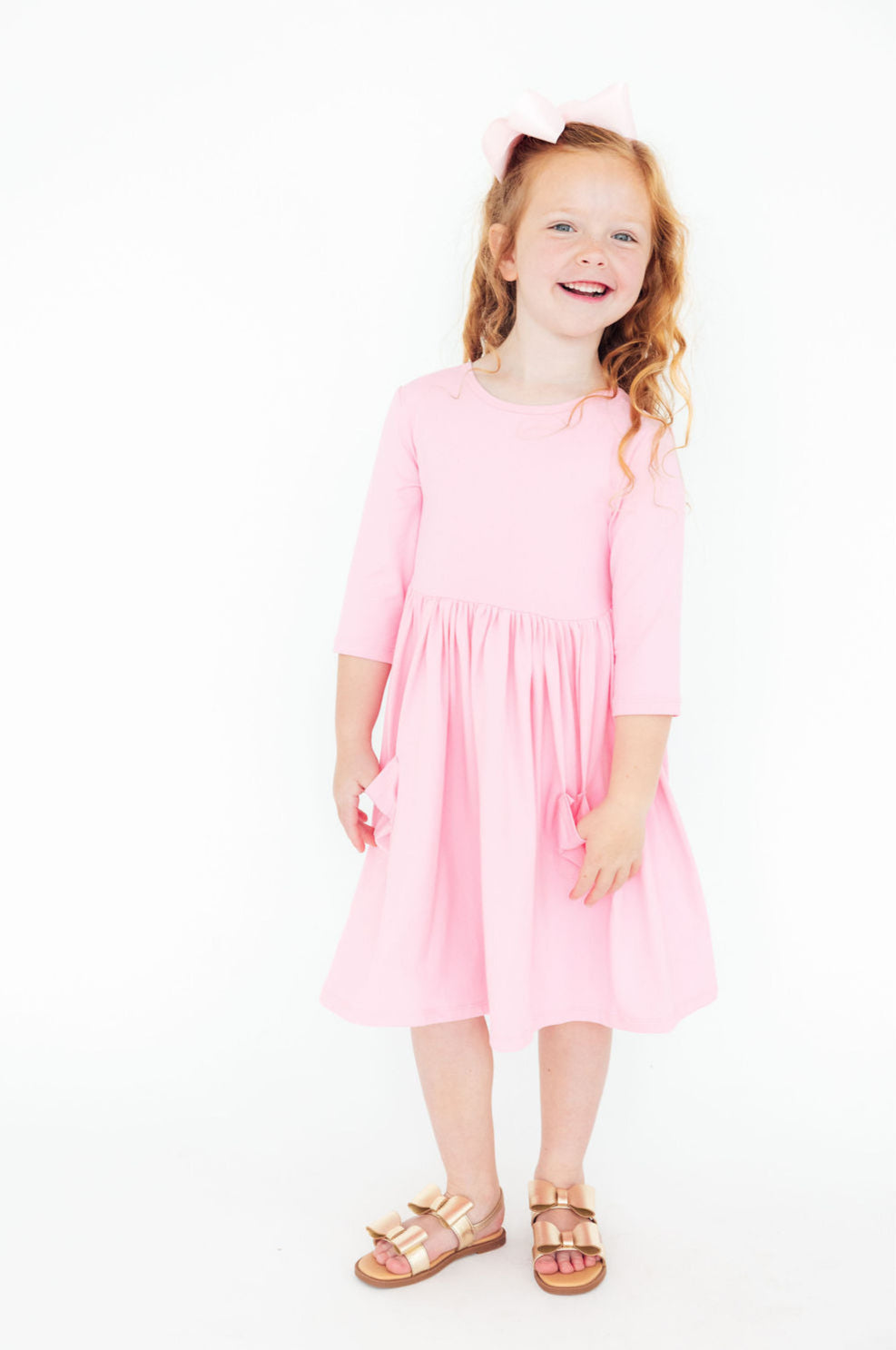 Bubblegum Pink 3/4 Sleeve Pocket Twirl Dress for Girls displayed on a cute mannequin, showcasing its vibrant color and twirl-friendly design.