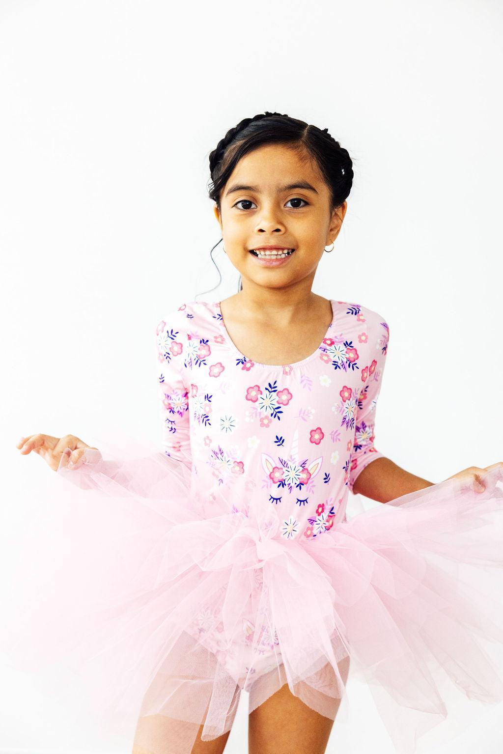 Cute little dancer in the Retro Daydream 3/4 Sleeve Tutu Leotard by Mila & Rose, twirling with joy in a fluffy tutu.