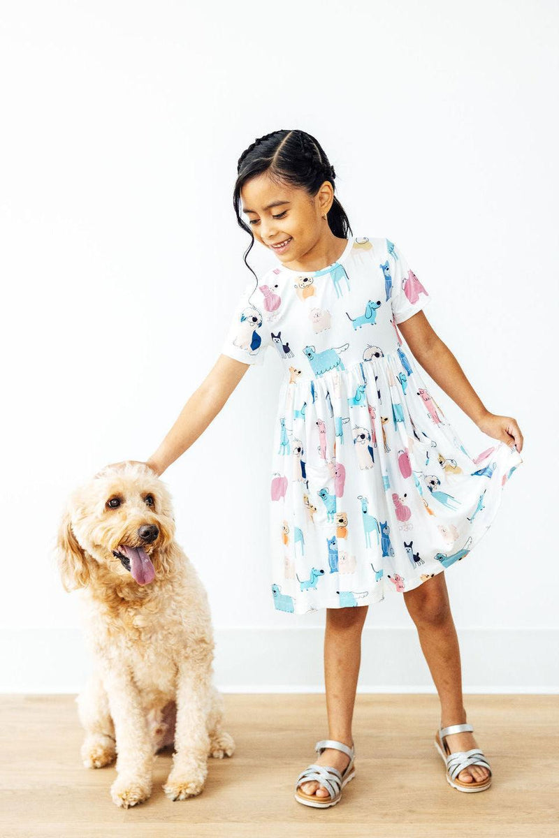Stylish little ones modeling the Puppy Pals S/S Pocket Twirl Dress, making playtime oh-so fashionable!