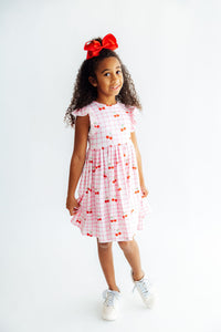 Girls in Cherry Sweet Flutter Sleeve Twirl Dress, embracing fun and movement.