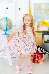 Playground Princess short sleeve twirl dress with vehicle print, girl twirls in a colorful classroom playroom.