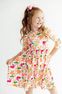 Girl in Falling Leaves 3/4 Sleeve Pocket Twirl Dress with colorful leaf print and full twirl skirt.