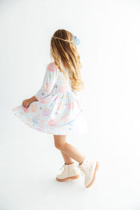 Here for the Candy 3/4 Sleeve Pocket Twirl Dress for Girls, pastel print, twirling with white boots.