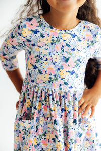 Girl wearing Fall Floral 3/4 Sleeve Pocket Twirl Dress for Girls with pastel print, pockets, full twirl skirt.