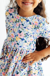 Girl wearing Fall Floral 3/4 Sleeve Pocket Twirl Dress for Girls with a full twirl skirt and pockets.