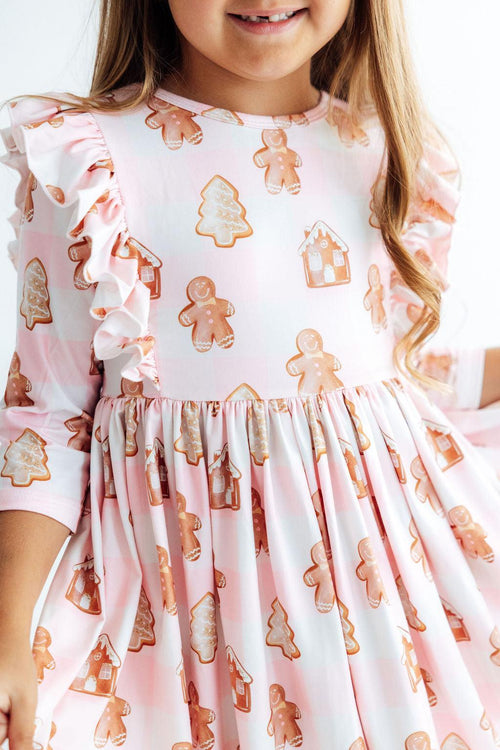 Pink plaid Christmas dress with gingerbread print, ruffled 3/4 sleeves, and twirly skirt for holiday parties.