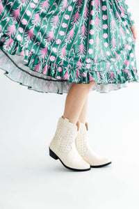 Christmas Treats Long Sleeve Ruffle Hem Twirl Dress with a twirl skirt in green-pink pattern, white boots.