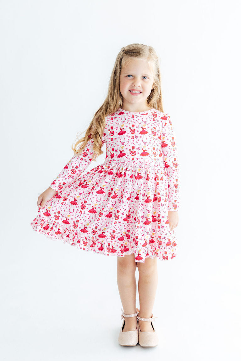 Candy Cane Ballet Long Sleeve Ruffle Hem Twirl Dress on a smiling girl in pink print, full twirl skirt.