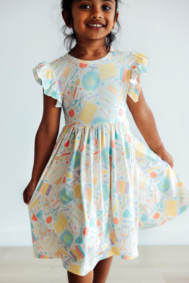 Get ready to spin in the Campus Cutie Flutter Sleeve Twirl Dress for Girls, designed for comfort and fun with its easy scoop back.