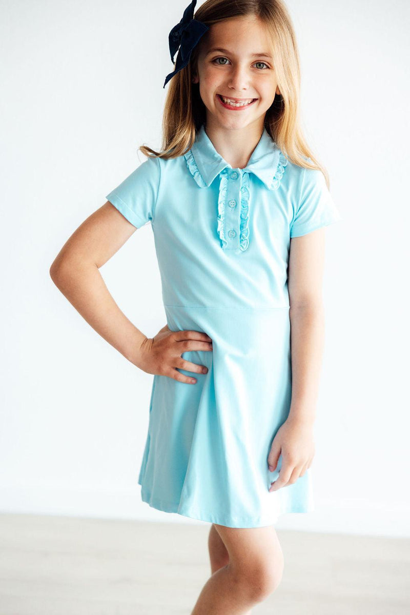 The Bluebird S/S Polo Dress styled for a casual outing, emphasizing its versatility for school and family gatherings.