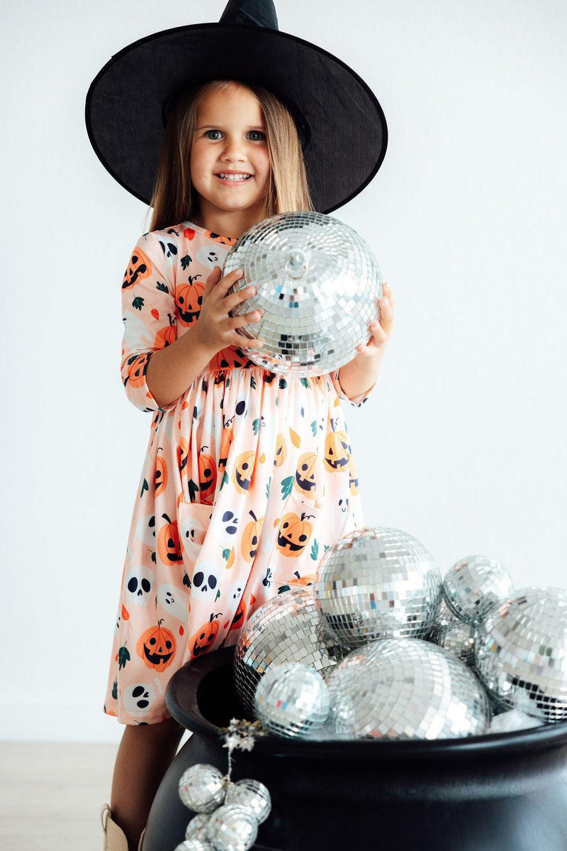 Playful close-up of the Pumpkin Peekaboo 3/4 Sleeve Pocket Twirl Dress, highlighting its fun design and soft, stretchy material.