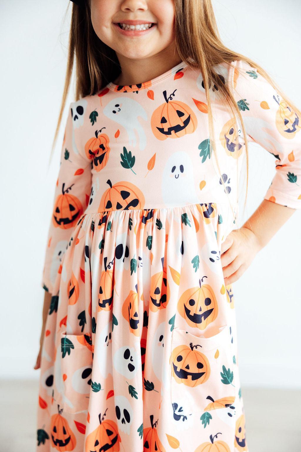 Adorable Pumpkin Peekaboo 3/4 Sleeve Pocket Twirl Dress, perfect for playful spins and Halloween fun, showcased in a delightful twirling pose.