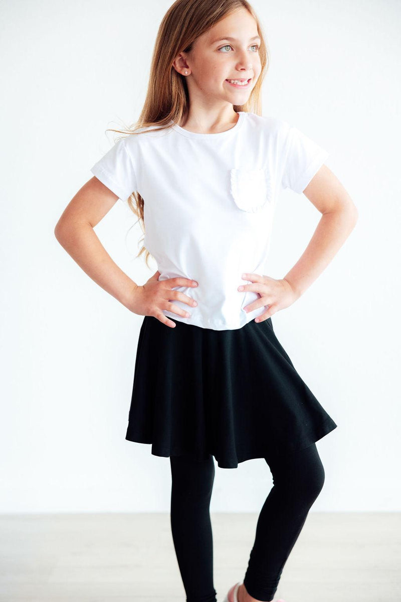 Chic Black Twirl Skegging shown on a young girl posing confidently in a white top and stylish black skirt with leggings, perfect for ages 2 to 10 years.