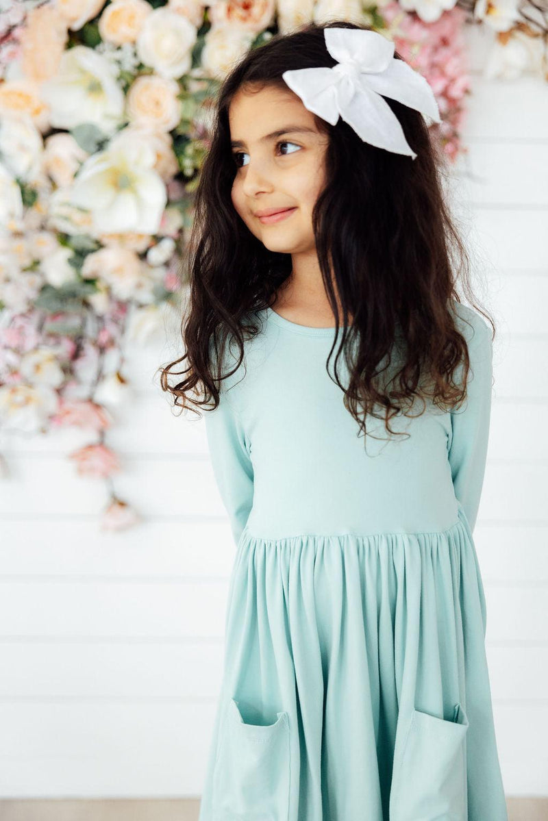 Cute and playful Sage 3/4 Sleeve Pocket Twirl Dress from Mila & Rose®, designed for little girls, featuring a fun twirly skirt and soft, breathable fabric for all-day comfort.