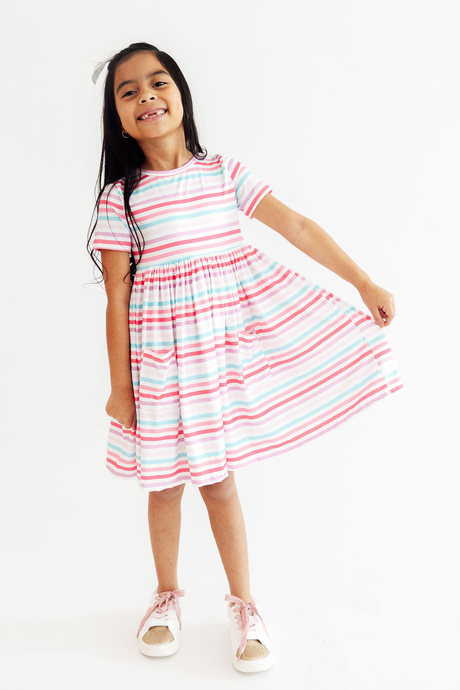 Girls wearing the Pastel Stripes Short Sleeve Twirl Dress with Pockets, showcasing this fun and vibrant girls twirl dress.