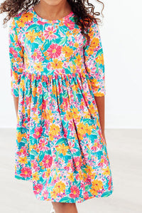 Floral Fiesta 3/4 Sleeve Pocket Twirl Dress with bright florals, scoop back, ballet neckline, and full twirl skirt.