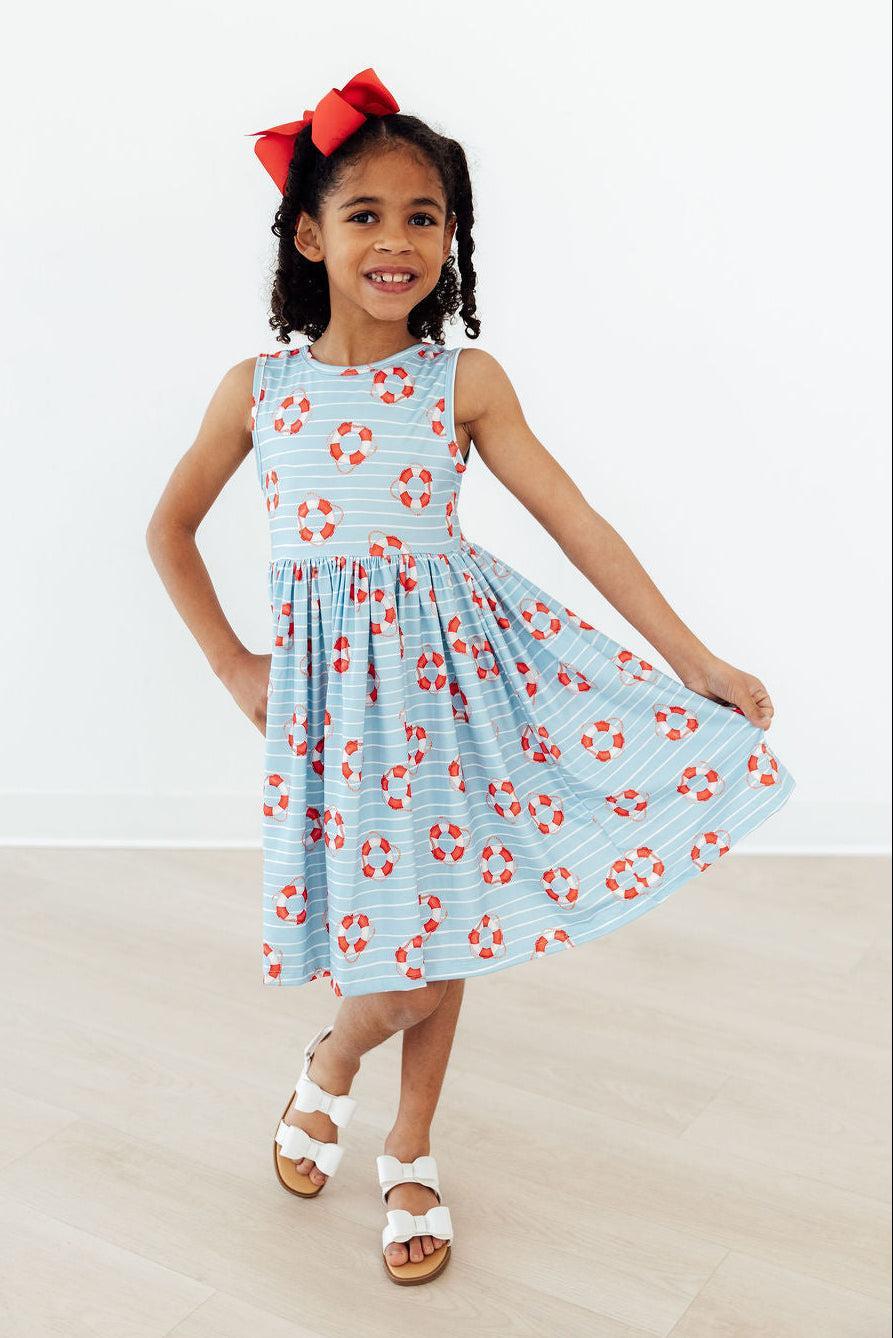 The Little Lifeguard Playful Tank Twirl Dress for Girls styled with twirl shorts, showcasing versatile styling options for every season.