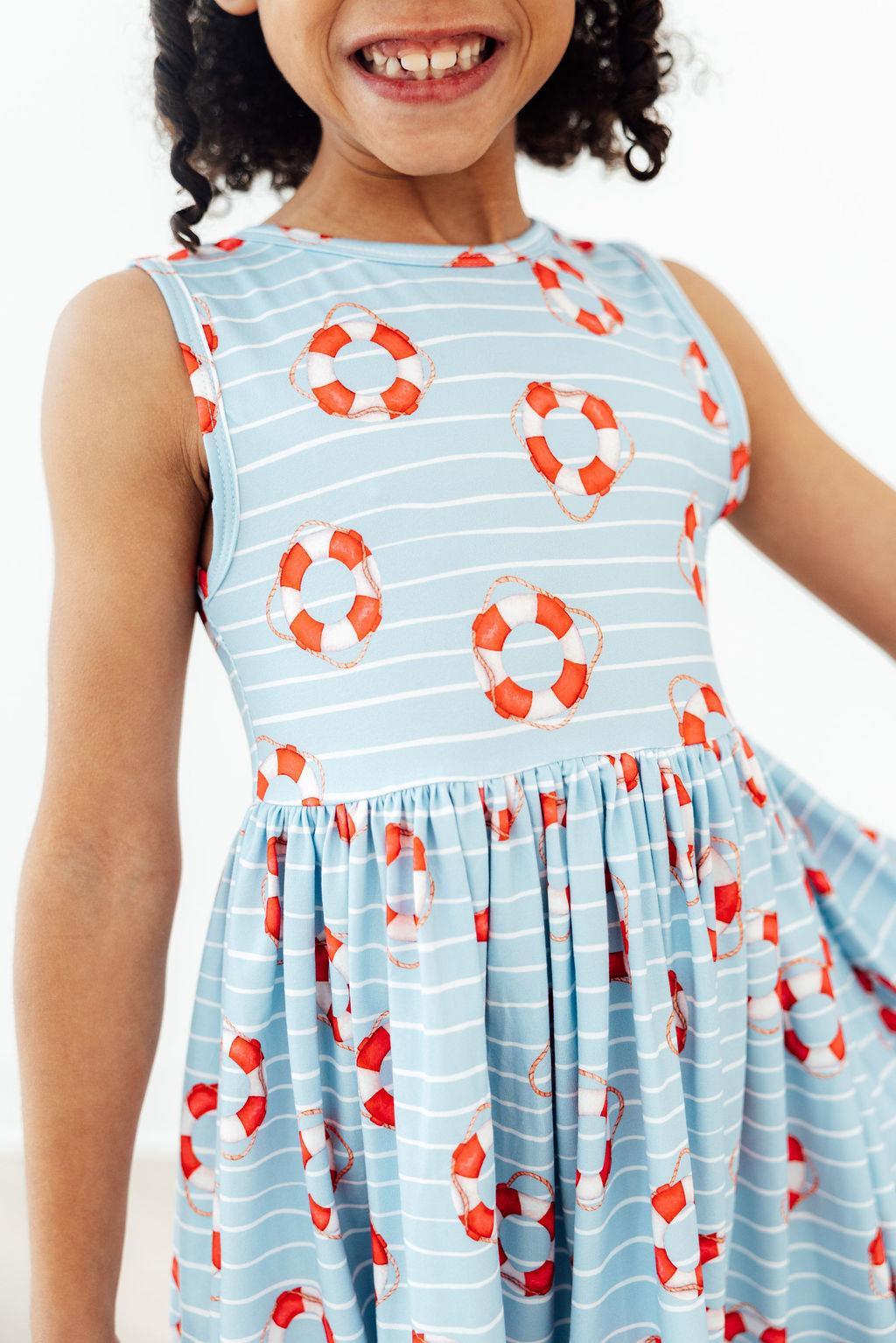Little Lifeguard Playful Tank Twirl Dress for Girls showcasing a vibrant design perfect for sunny days. Ideal playful tank dress for school or play.