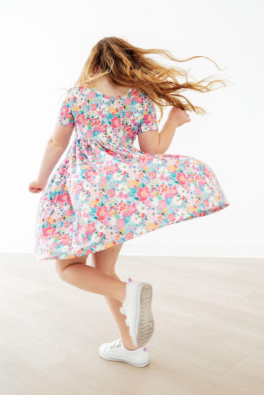Petal Promises short sleeve pocket twirl dress in a vibrant floral print, perfect for school or play.