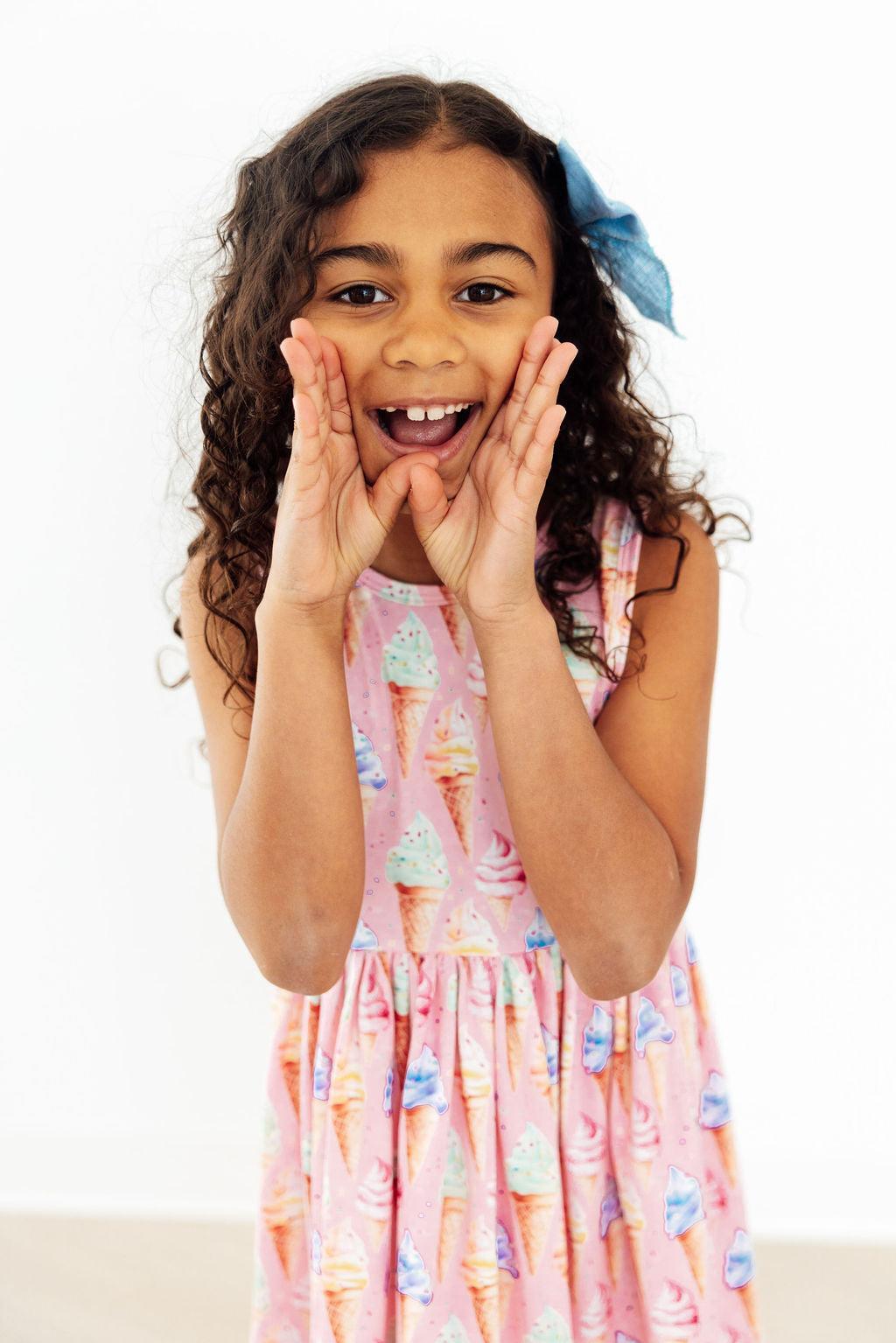Little girl twirling in the Ice Cream Dreams Tank Twirl Dress For Girls, a perfect twirl dress for girls for playground fun.