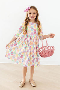 Egg-stra Cute 3/4 Sleeve Pocket Twirl Dress worn by a smiling girl in pastel bow-print twirl design.