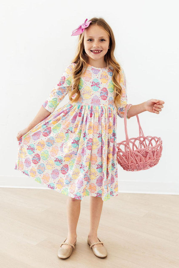 Egg-stra Cute 3/4 Sleeve Pocket Twirl Dress worn by a smiling girl in pastel bow-print twirl design.