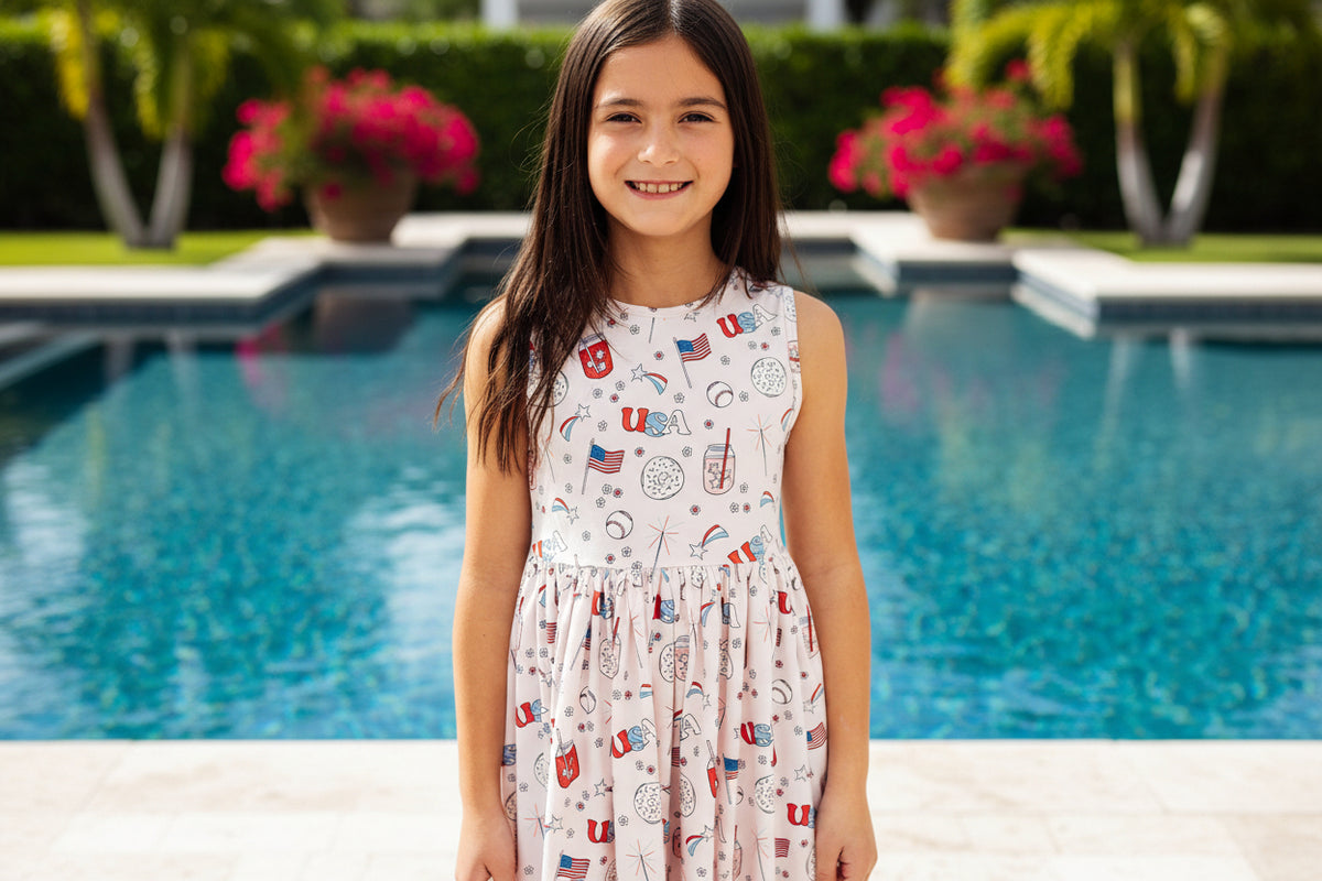 Girl in Born in the USA Tank Twirl Dress with a full twirl skirt and patriotic USA print.