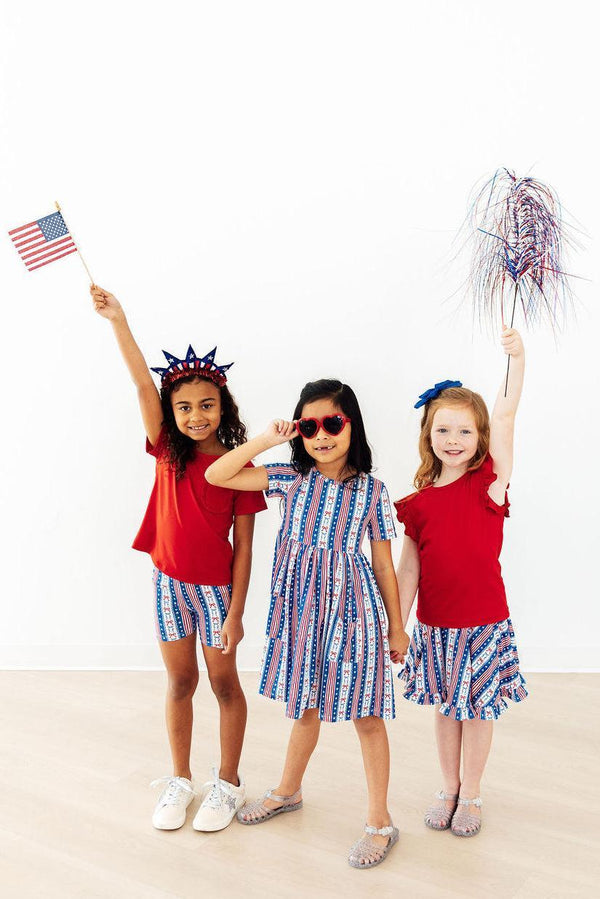 All-American Girl Short Sleeve Pocket Twirl Dress worn by three kids in patriotic red, white, and blue outfits.