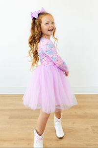 Girl in pink long sleeve tutu dress with light bulb print and white cowboy boots. Perfect dress for dressing up or special occasions.