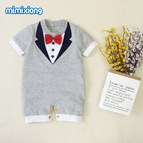 gray baby boy knit romper with red bow tie and navy tuxedo design for infants