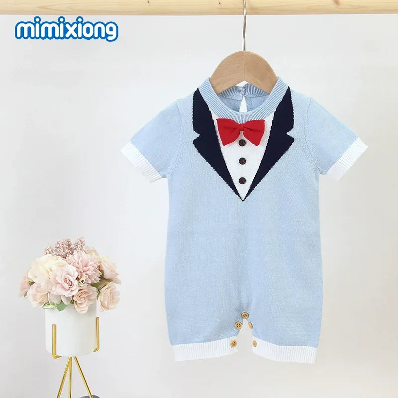 baby boy knit romper in light blue with black tuxedo design and red bow tie for infants